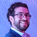 Headshot of Ariel Himmelstern, Co-Founder and CTO of RoomSync, smiling in a vibrant, professional setting.