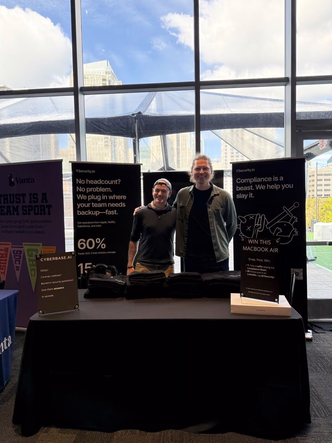 The YSecurity booth at BSides San Francisco: two banners, one table, swag ready
