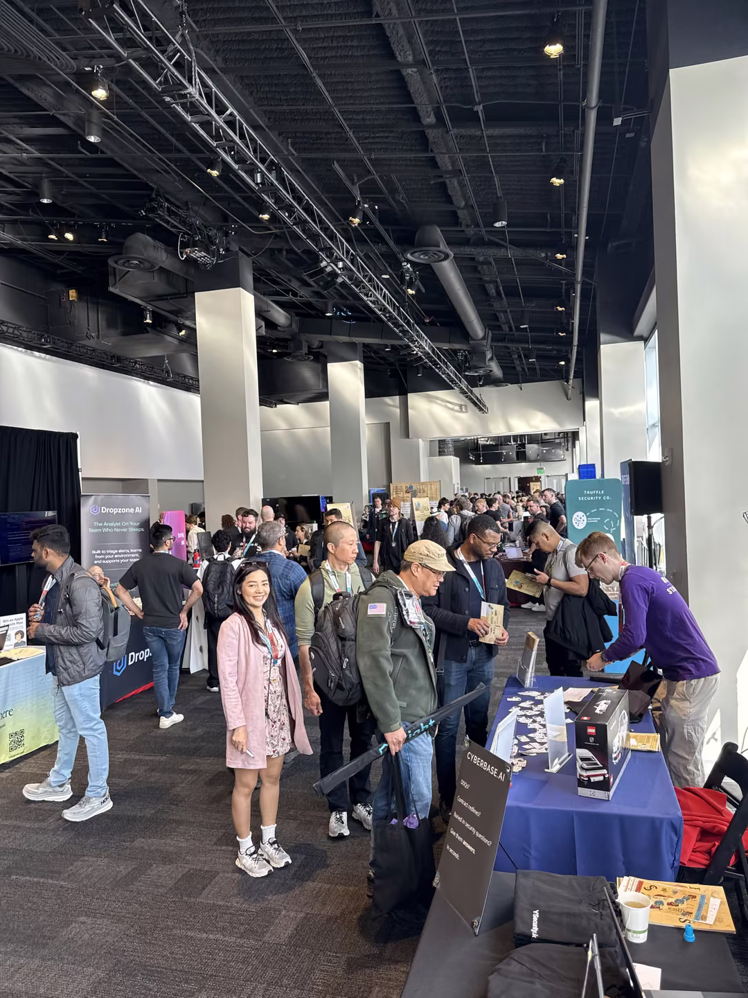 The BSidesSF expo floor at full capacity, with attendees crowding the vendor tables