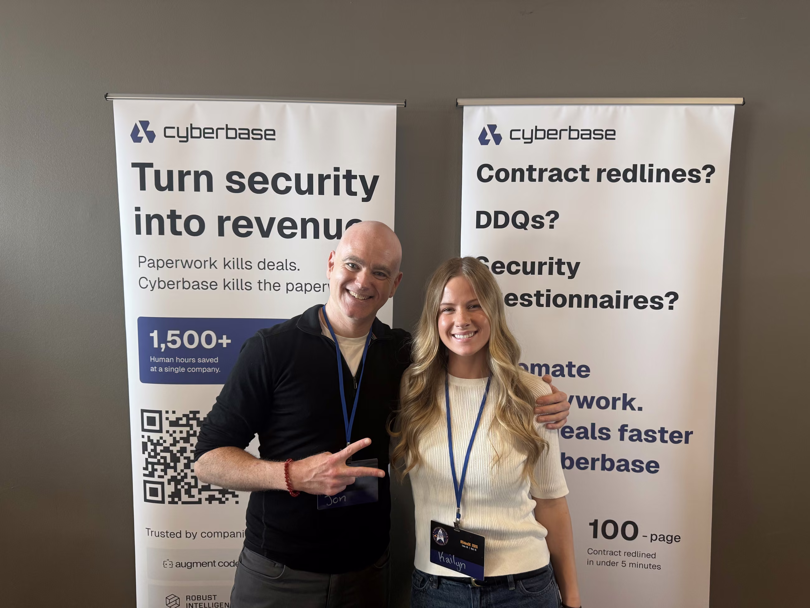 Two team members at the Cyberbase banners at BSidesOK in Tulsa