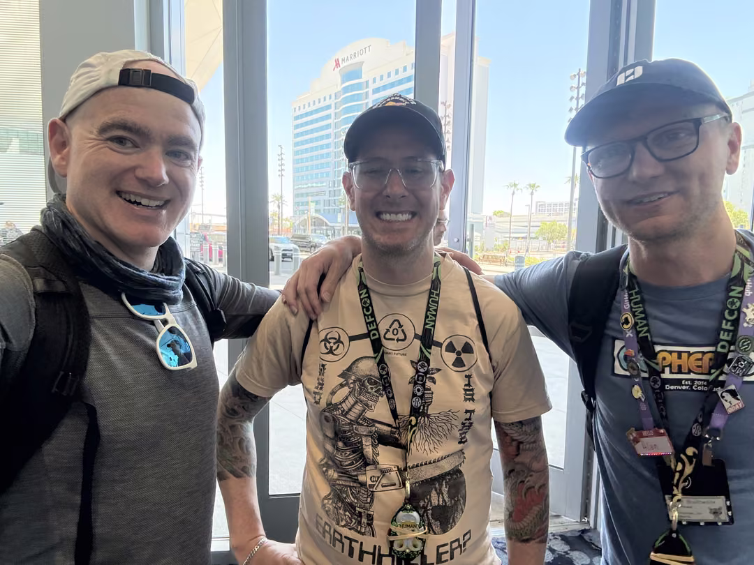Three friends outside the Las Vegas Convention Center during DEF CON 33, the August regulars catching up between talks