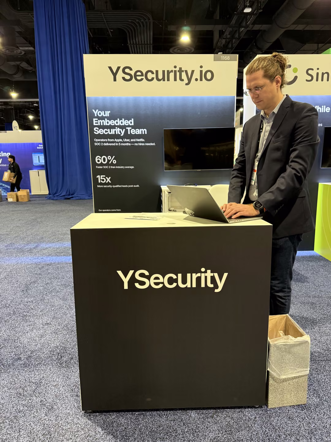 A YSecurity team member working at the booth podium on the Gartner Security & Risk Management Summit expo floor