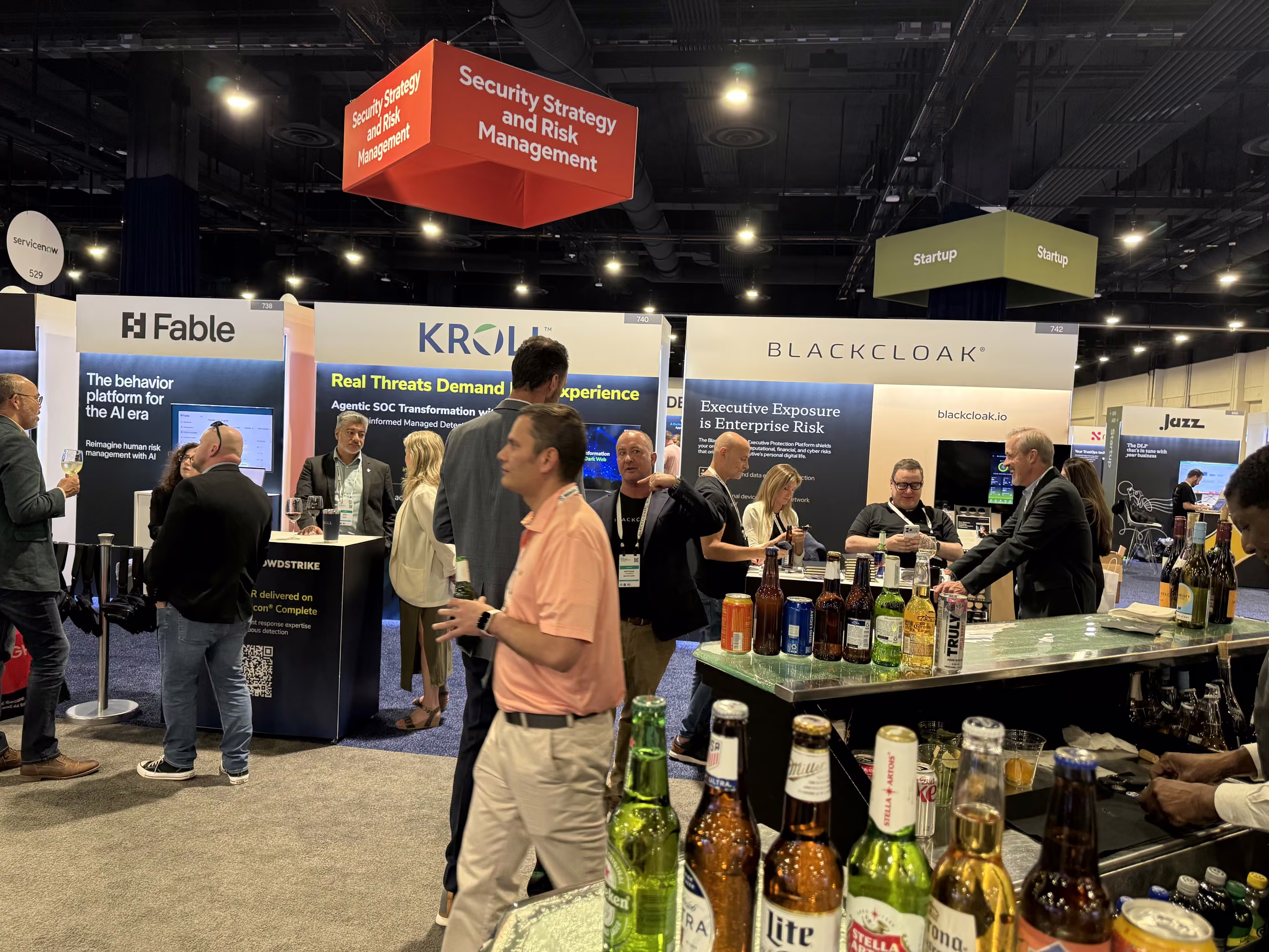 The expo floor at five o’clock, drinks cart out and crowds loosening up