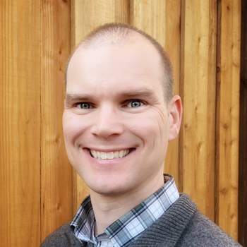 Headshot of Mike Edwards from Stealth, smiling in a casual professional environment.