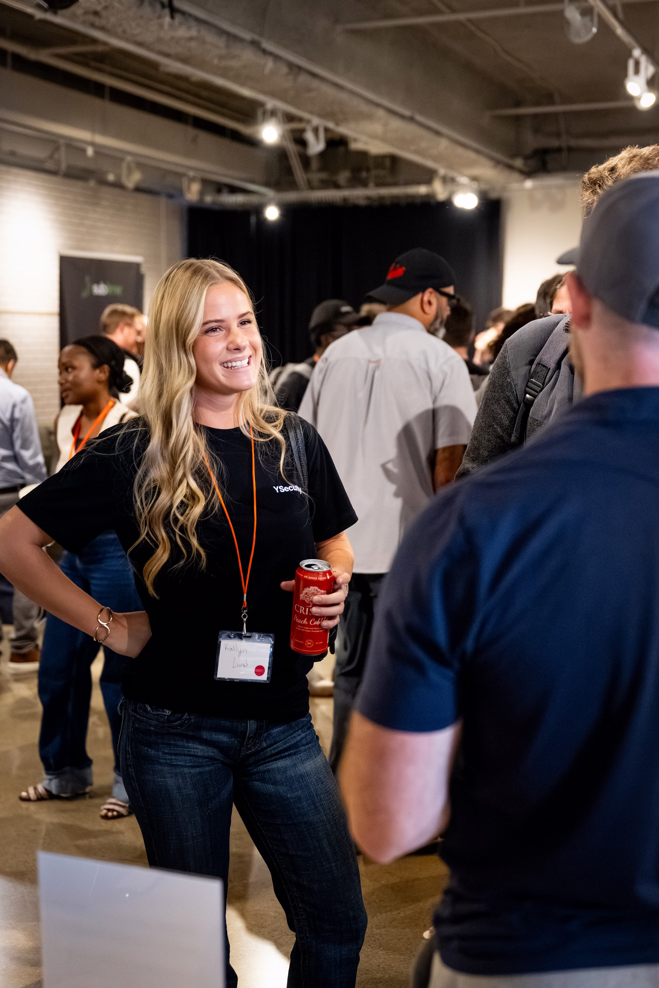 Kailyn Lund of YSecurity smiling mid-conversation with an attendee at Twin Cities Startup Week
