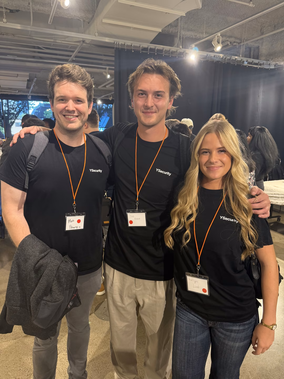 Matt Harrison, Joe Kleve and Kailyn Lund of YSecurity in branded shirts and name badges at Twin Cities Startup Week