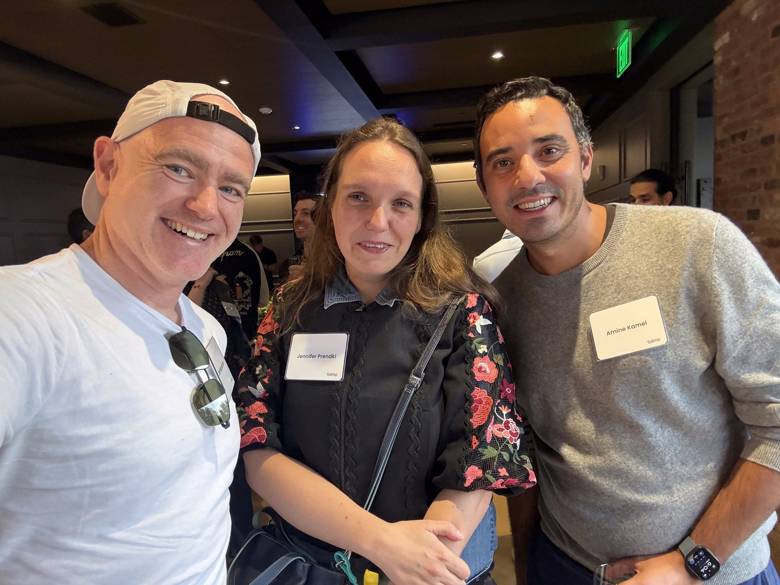 Jon McLachlan of YSecurity smiling with two fellow attendees in the crowd at Tolmo Day