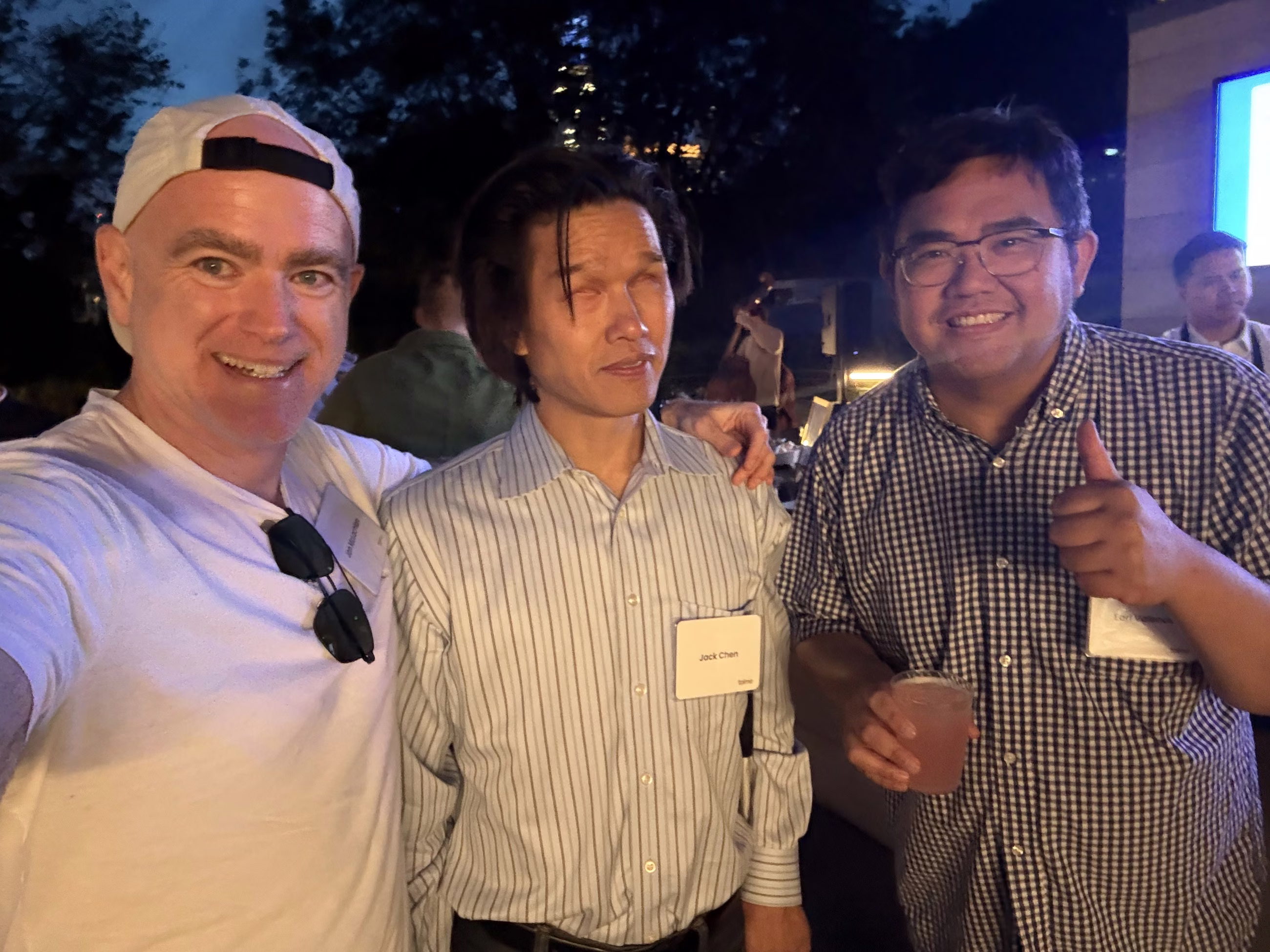 Jon McLachlan of YSecurity with two new friends on the Accel rooftop at night, one giving a thumbs up